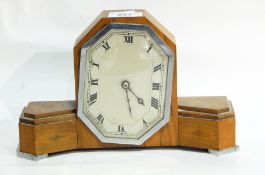 An Art Deco style mantel clock in a walnut case, with octagonal silvered dial,