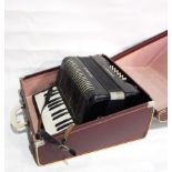 A piano accordion, three framed pictures, cigarette cards of trains,