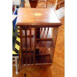 An Edwardian mahogany revolving bookcase with inlaid satinwood top,