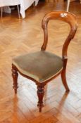 A pair of Victorian mahogany balloon back dining chairs, with carved scrollwork supports,
