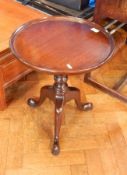 A Broughton Manor mahogany wine table, circular on turned and knopped column three scroll supports,