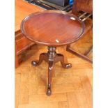 A Broughton Manor mahogany wine table, circular on turned and knopped column three scroll supports,