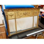 A rectangular gilt Regency style mirror with urn and swag decoration, with "Jones & Higgins,