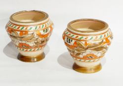 A pair of Crown Ducal Charlotte Rhead vases of ribbed form with tube lined floral decoration,
