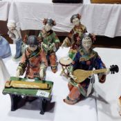 Four Oriental female figures seated,