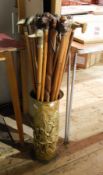 Large collection of walking sticks with animal heads to include carved, brass coloured metal,