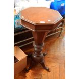 A 19th century octagonal occasional table on octagonal tapering and bun supports,