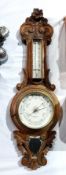 Carved oak aneroid barometer made by H Husbands & co.