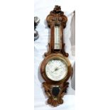 Carved oak aneroid barometer made by H Husbands & co.
