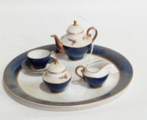 A Caverswall miniature doll's teaset comprising teapot, sugar pot and cover, teacup and saucer,