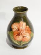 A Moorcroft vase of baluster form with hibiscus on green ground,