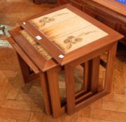 A nest of three rectangular tiled top occasional tables, Danish style, stamped "Keith Eatwell",