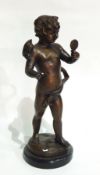 Bronze figure of Putto holding hand mirror on black circular marble plinth,