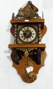 A bracket clock with oak case and elaborate brasswork decoration, twin train striking movement,