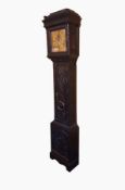 A 19th century ebonised and carved oak longcase clock, the carved frieze and column support,