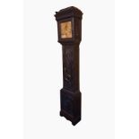 A 19th century ebonised and carved oak longcase clock, the carved frieze and column support,