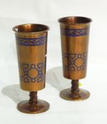 Pair of bronze pedestal vases painted gold with blue enamel geometric and scroll decoration,