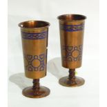 Pair of bronze pedestal vases painted gold with blue enamel geometric and scroll decoration,