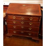 A George III mahogany bureau, with crossbanding,