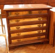 A Canaleto Spanish handmade walnut and brass chest of five drawers, on shaped bracket feet,