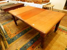 A Victorian mahogany extending dining table on turned legs,