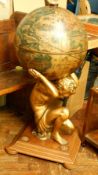 A globe drinks cabinet modelled as Atlas supporting the world,