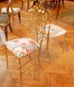 A pair of vintage brass Chiavari gilt metal salon chairs with spindle splats,