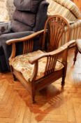 An old adjustable armchair, with hoop back and pierced splats, cushion seats,