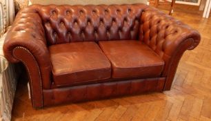 A two seater brown leather sofa,