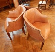 A set of three studded leather armchairs,