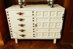 A stained white sideboard with five drawers and cupboard to right hand side,