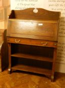 An early 20th century oak bureau, the fall-front over a single drawer with shelves below,