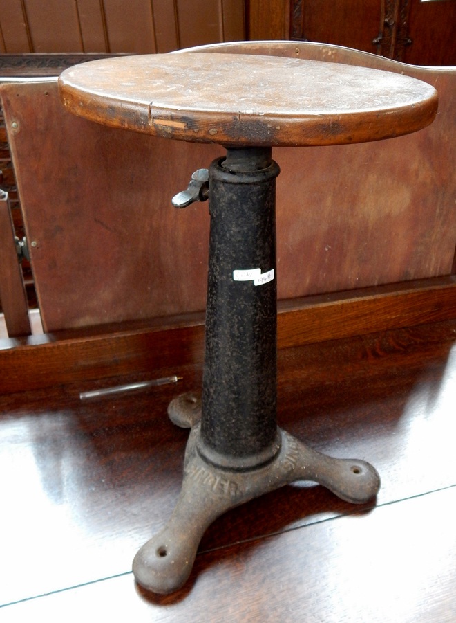 A cast iron Singer stool,