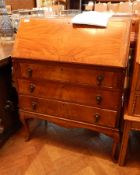 A mahogany bureau with three graduating drawers, on cabriole legs, fitted interior,