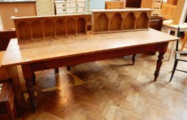 A 19th century pine refectory table on ball and tapering legs,