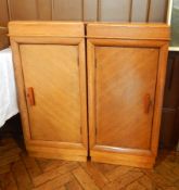 A pair of 20th century oak cupboards with bakelite handles,