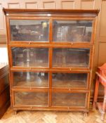 A stained oak Globe-Wernicke style sectional bookcase with four sections, on claw feet,