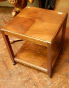 A walnut two-tier square coffee table on castors,