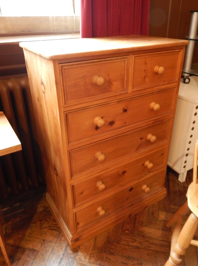A pine chest of two short and four long drawers, on block plinth with bun handles,