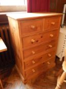 A pine chest of two short and four long drawers, on block plinth with bun handles,