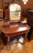 A Victorian mahogany dressing table with integral swing toilet mirror and two drawers below,