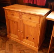 A pine cupboard with two short drawers and under cupboard,