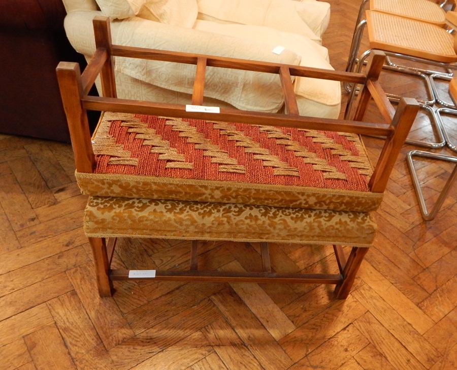 Two gold floral decorated footstools on square legs and united by stretchers