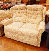 Two seater sofa, with button back cushions, floral print upholstery,