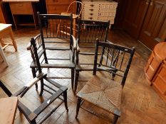 A pair of William Morris Sussex style carvers' chairs and two Sussex style dining chairs (missing