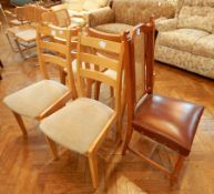 A set of four contemporary beech ladder back dining chairs with upholstered seats on square legs,