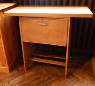 A 1960's swivel-top pine coffee table with under-cupboard and internal cutlery drawer,