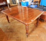 A Victorian mahogany extending dining table on turned legs,