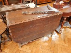 An 19th century oak gateleg table on spirally twisted legs (one leg has broken off),