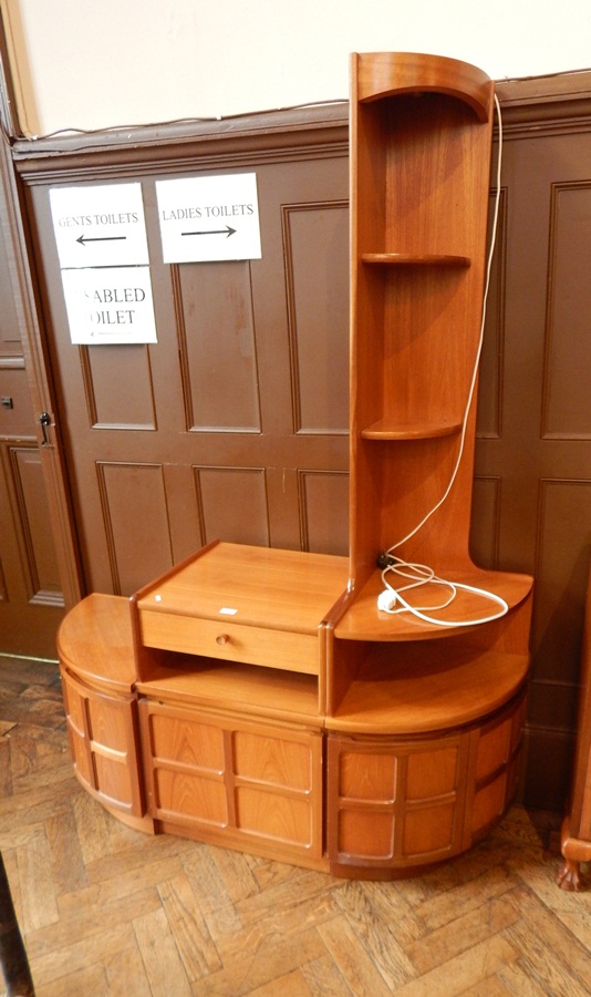 A Nathan teak living room unit with cupboards below and a corner shelf,